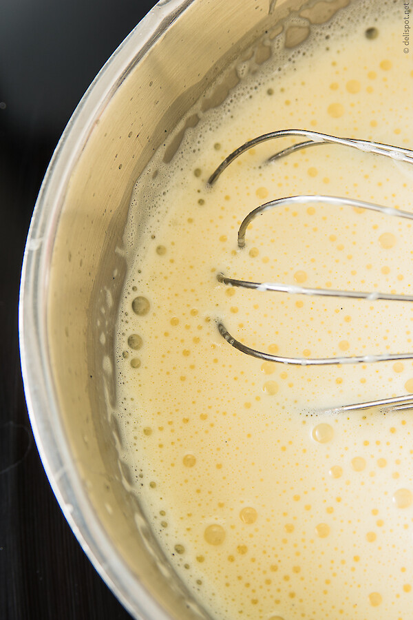 Vanillesauce, fertig aufgeschlagen, im Topf mit Schneebesen