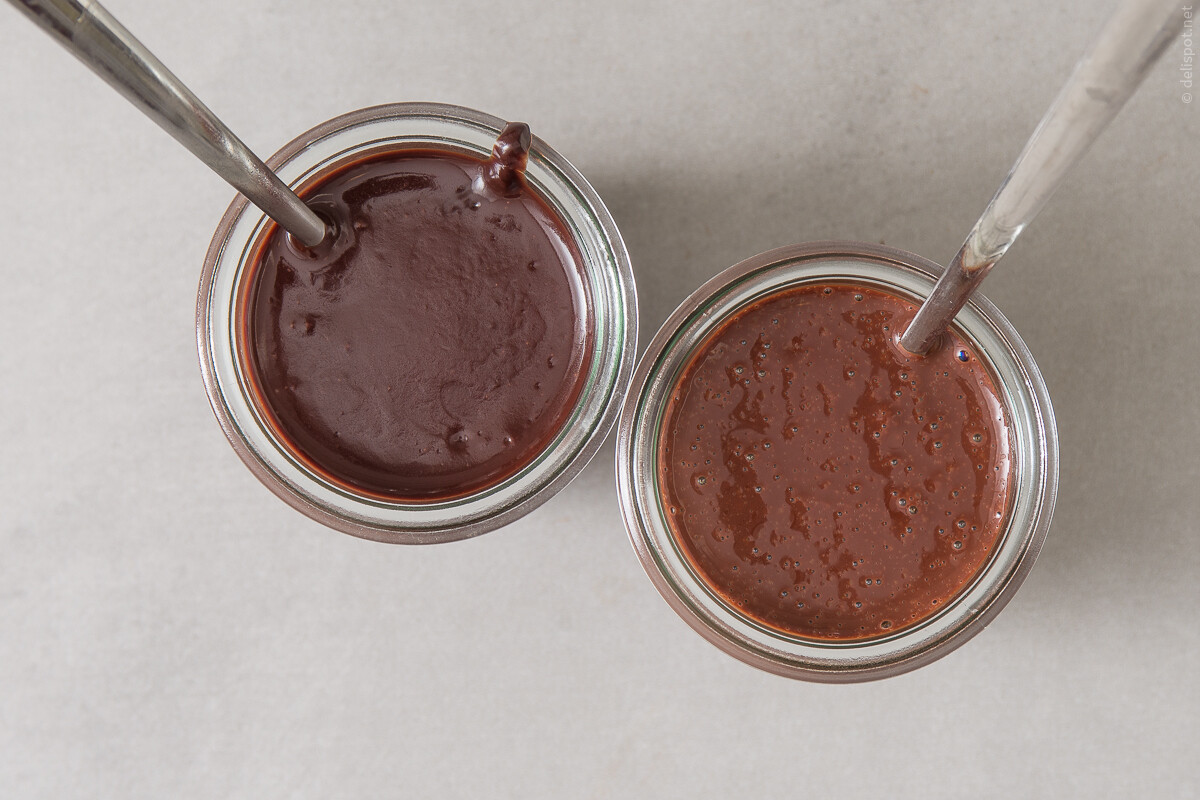 Schokoladensauce in zwei Varianten, abgefüllt in Gläsern: Chocolate Fudge Sauce (links) und einfache Grundsauce (rechts)